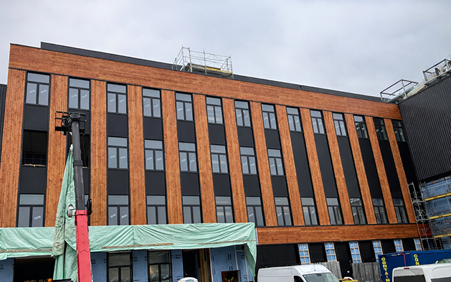 The building with the surface modified wooden facade.
